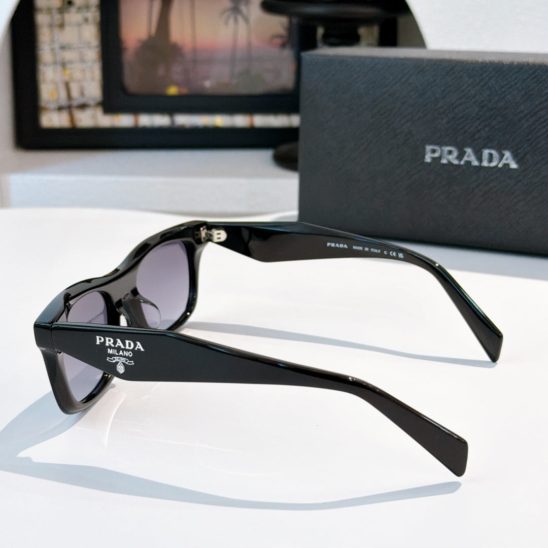 Black cat-eye sunglasses with purple gradient lenses and Prada logo on side