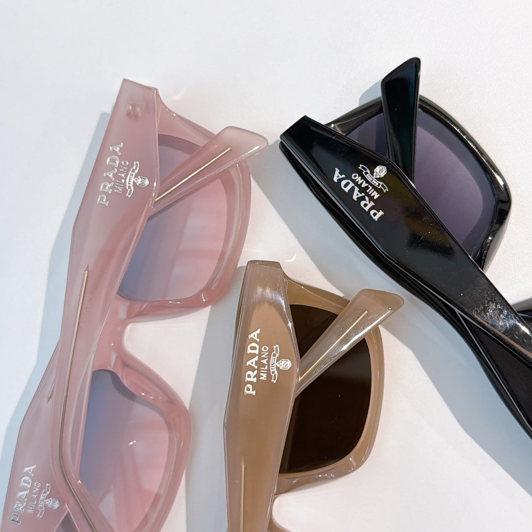 Pair of pink and black sunglasses with logo temples, shown side by side
