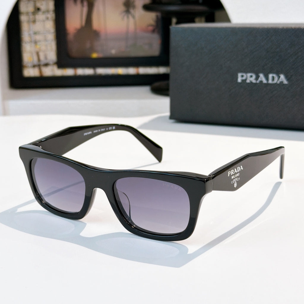 Black cat-eye sunglasses with dark purple gradient lenses and Prada logo on temple