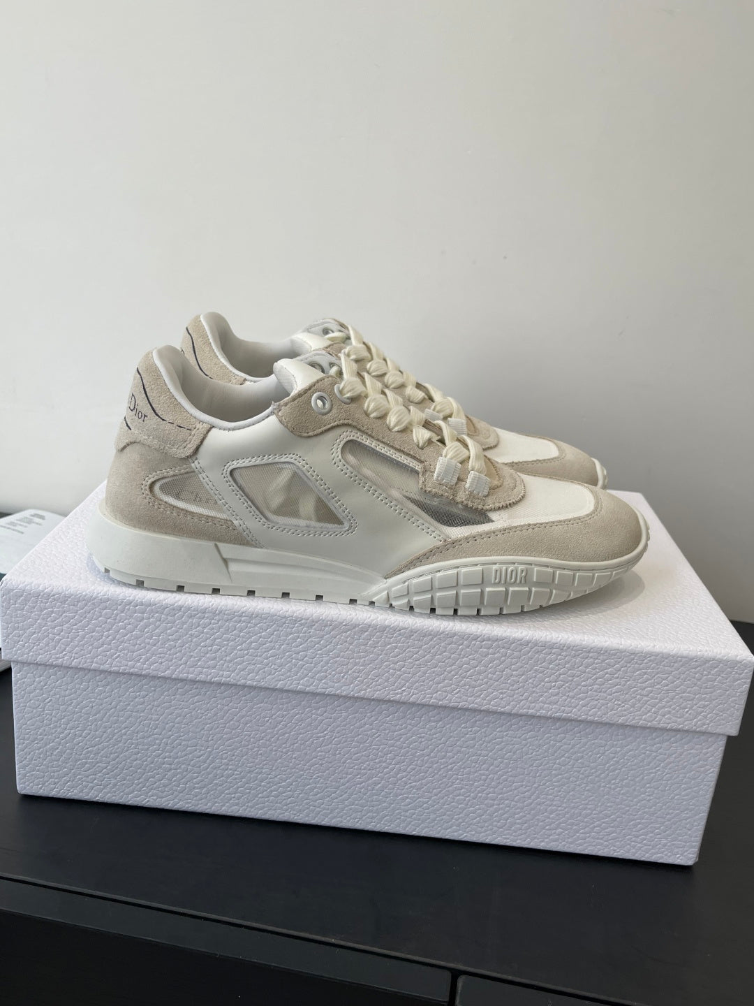Cream lace-up sneaker with side logo detail, perforated trim, and grippy outsole