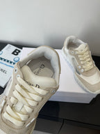 Cream lace-up sneakers with beige lining, top view of laces and eyelets