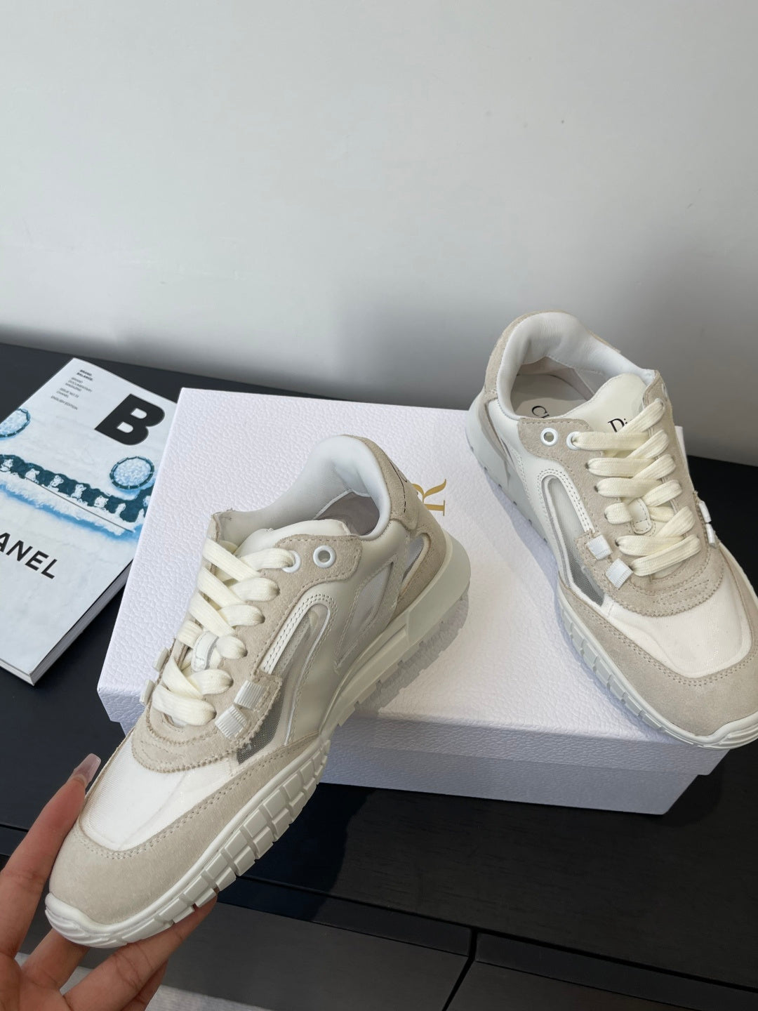 Cream lace-up sneakers, front and side view, with textured outsole and padded tongue