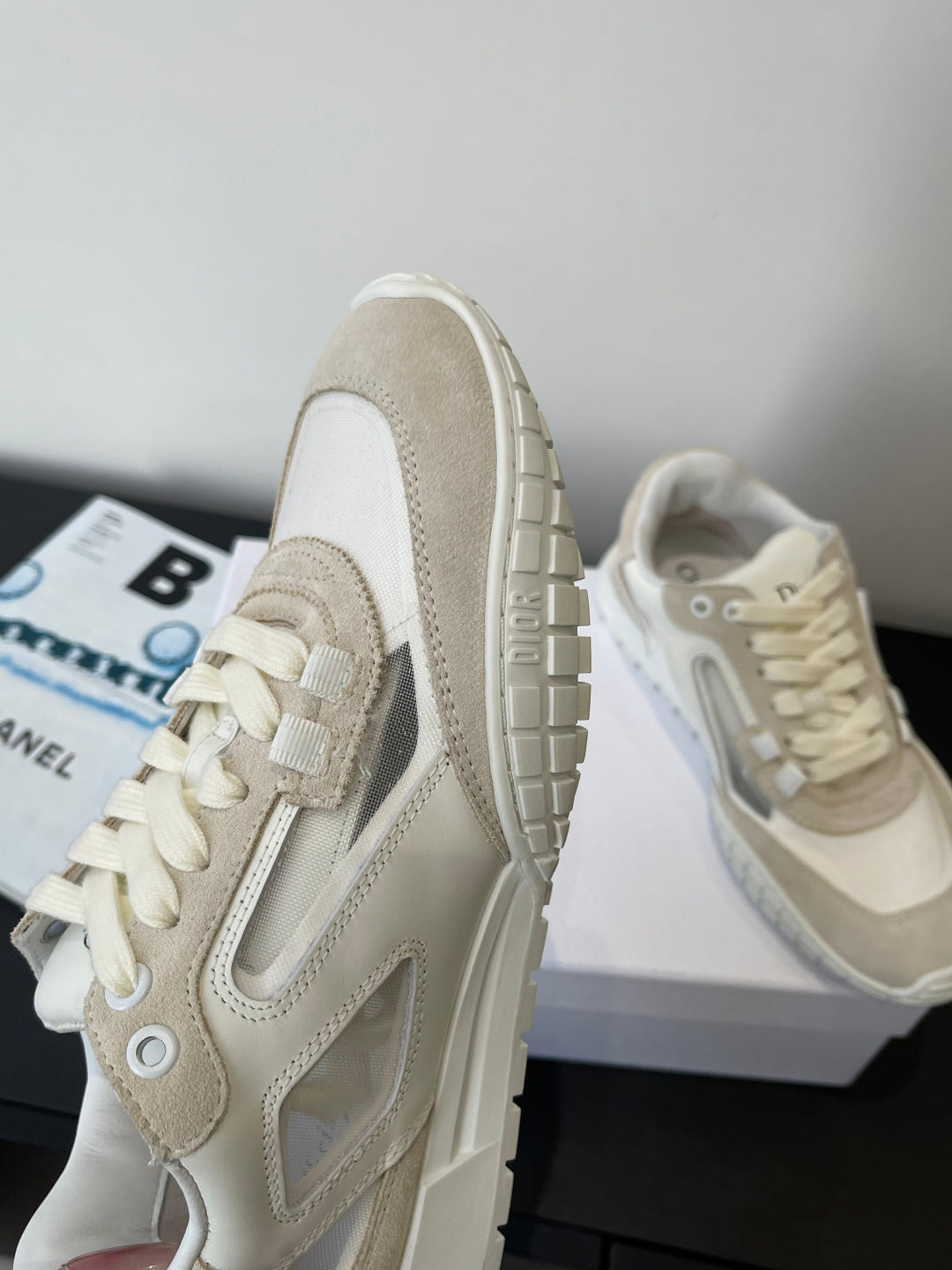 Cream lace-up sneakers with side panel stripe detail and textured rubber sole
