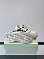 Shoe outsole view: white rubber sole with hex tread pattern on box