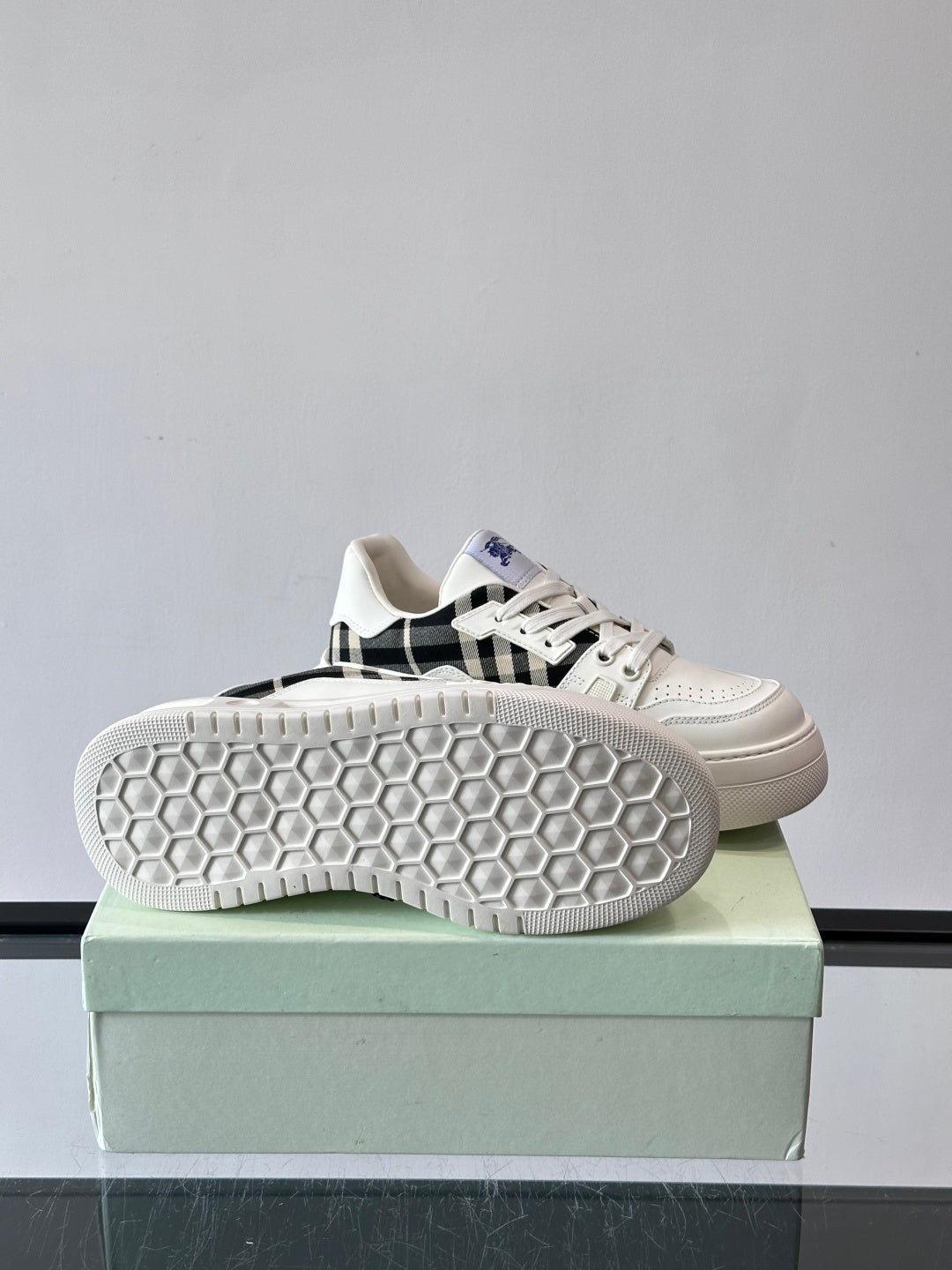 Shoe outsole view: white rubber sole with hex tread pattern on box