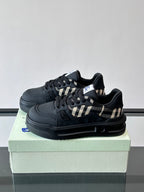 Black lace-up sneaker with check panel accent and grippy rubber sole