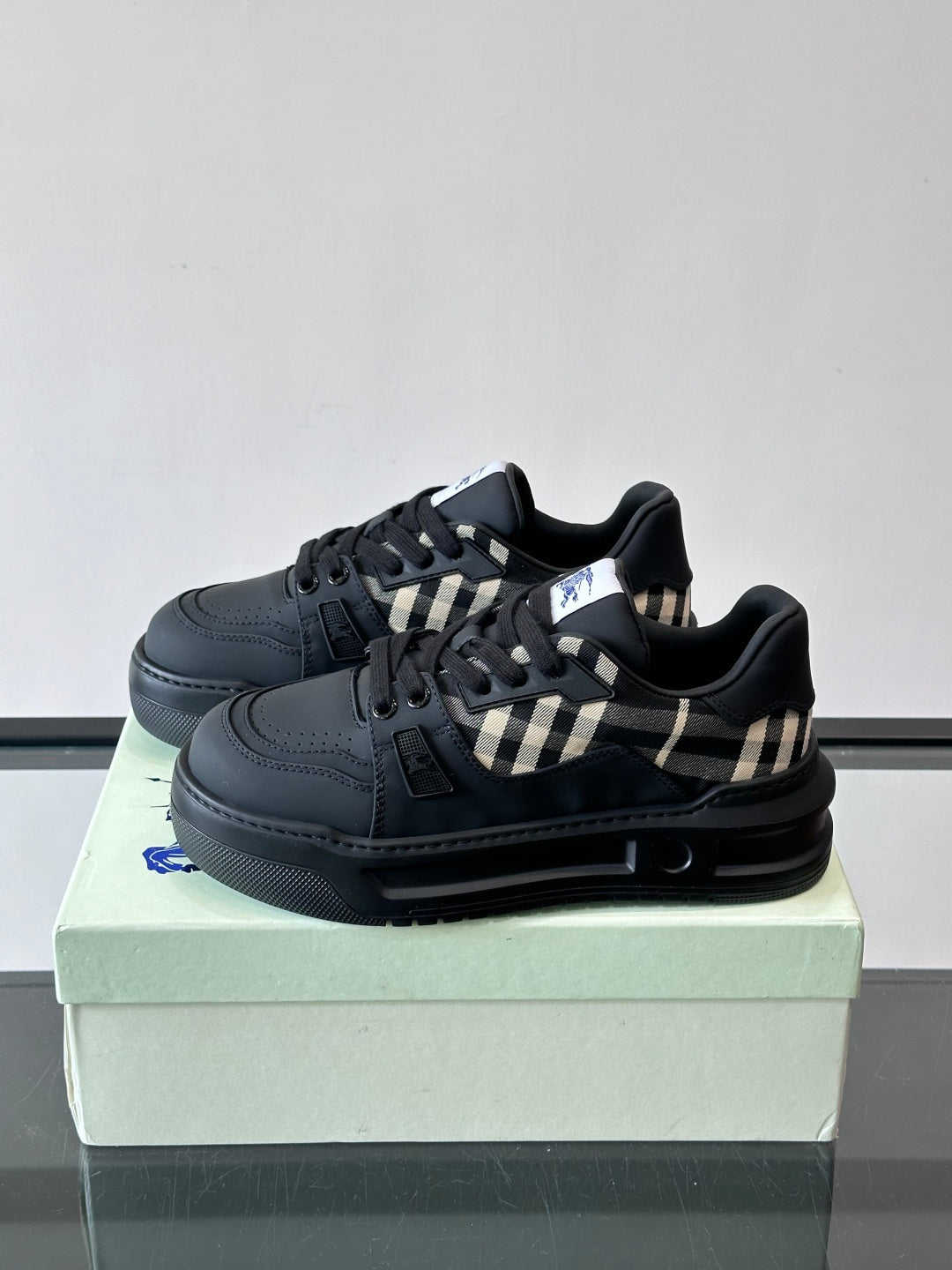 Black lace-up sneaker with check panel accent and grippy rubber sole