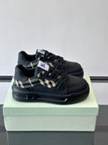Black lace-up sneakers with check panel detail and chunky rubber sole