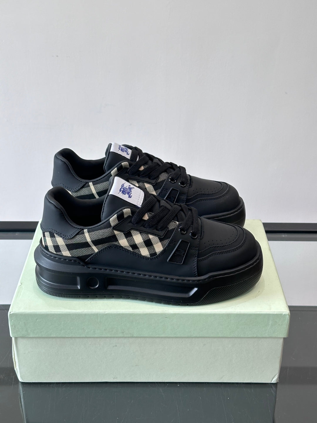Black lace-up sneakers with check panel detail and chunky rubber sole