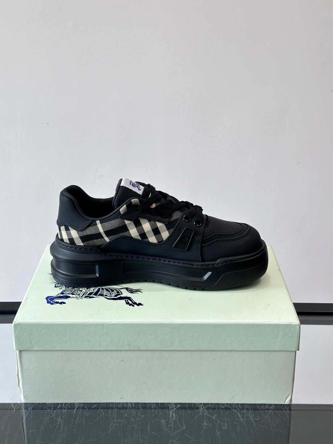 Black lace-up sneaker with check panel detail on the side strap
