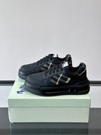 Pair of dark leather low-top sneakers, black laces, plaid logo panel, rubber sole