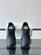 Dark leather low-top sneakers, black laces and plaid side detail