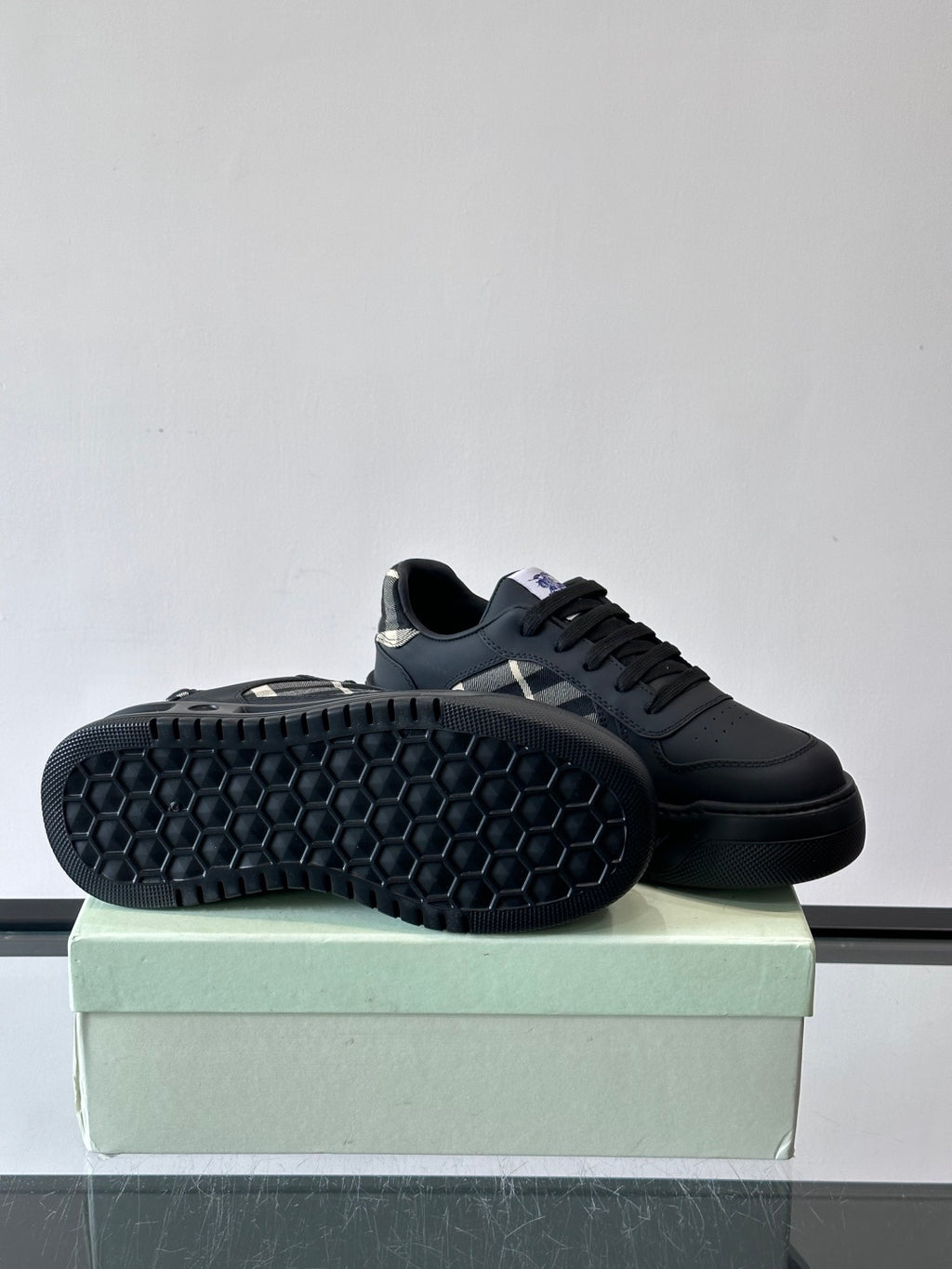 Low-top sneaker outsole, dark rubber tread with hex pattern