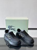 Dark leather sneakers with plaid accent, black laces, chunky rubber sole