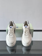 White leather-look sneakers with lace-up front and plaid accent near collar