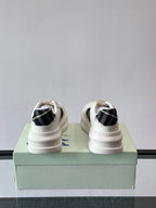 White leather-look sneakers with black plaid detail at back collar