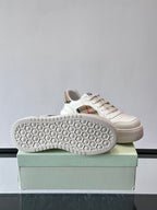 White sneaker outsole with hex-pattern tread, shown on box