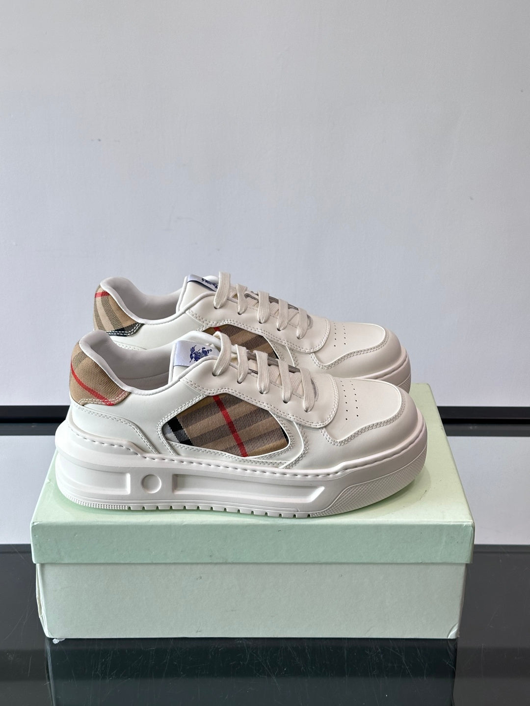 White leather sneakers with plaid side panel and lace-up front, low profile sole