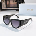 Cat-eye sunglasses with black frame and violet-tinted lenses.