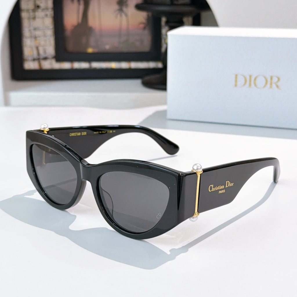 Cat-eye sunglasses with black frame and gray-tinted lenses.