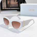 Cat-eye sunglasses with white frame and brown-tinted lenses.