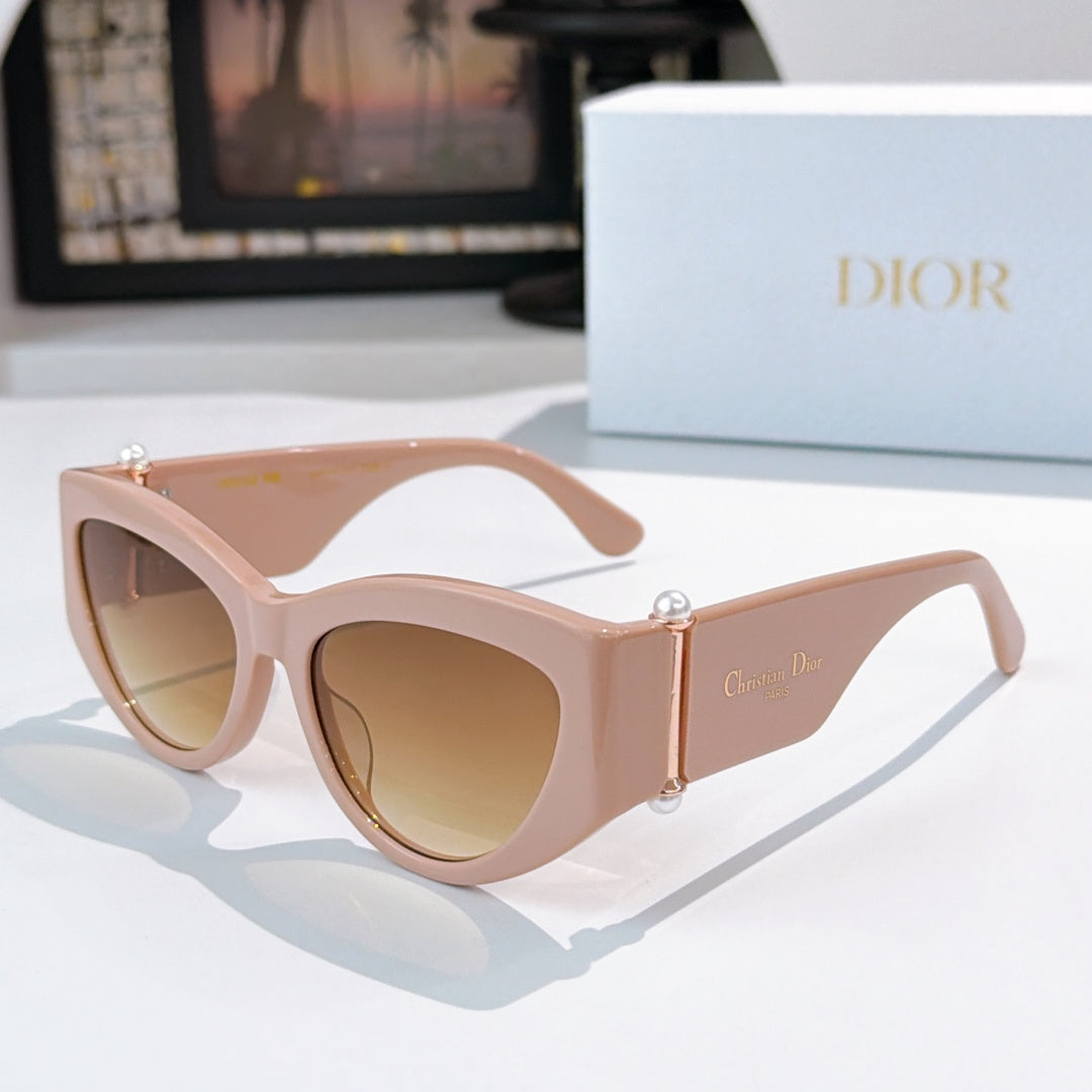 Cat-eye sunglasses with light pink frame and brown-tinted lenses.