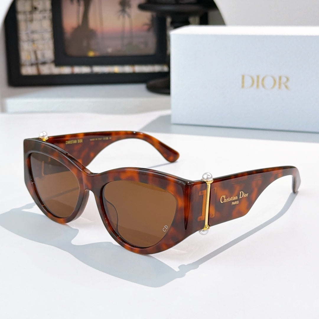 Cat-eye sunglasses with tortoiseshell frame and amber-brown lenses.
