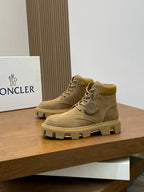 Suede lace-up ankle boots with logo medallion and padded collar.