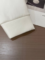 Folded white crewneck sweatshirt with small clothing label