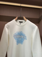 White crewneck sweatshirt with blue Versace graphic, close-up