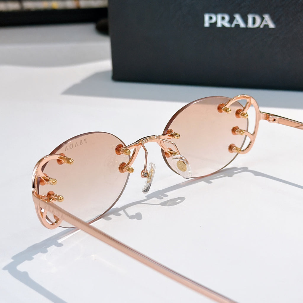 Prada sunglasses with round blush lenses and rose-gold studded frame, side view