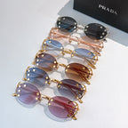 Set of Prada sunglasses with assorted colored lenses and gold-tone frames, stacked