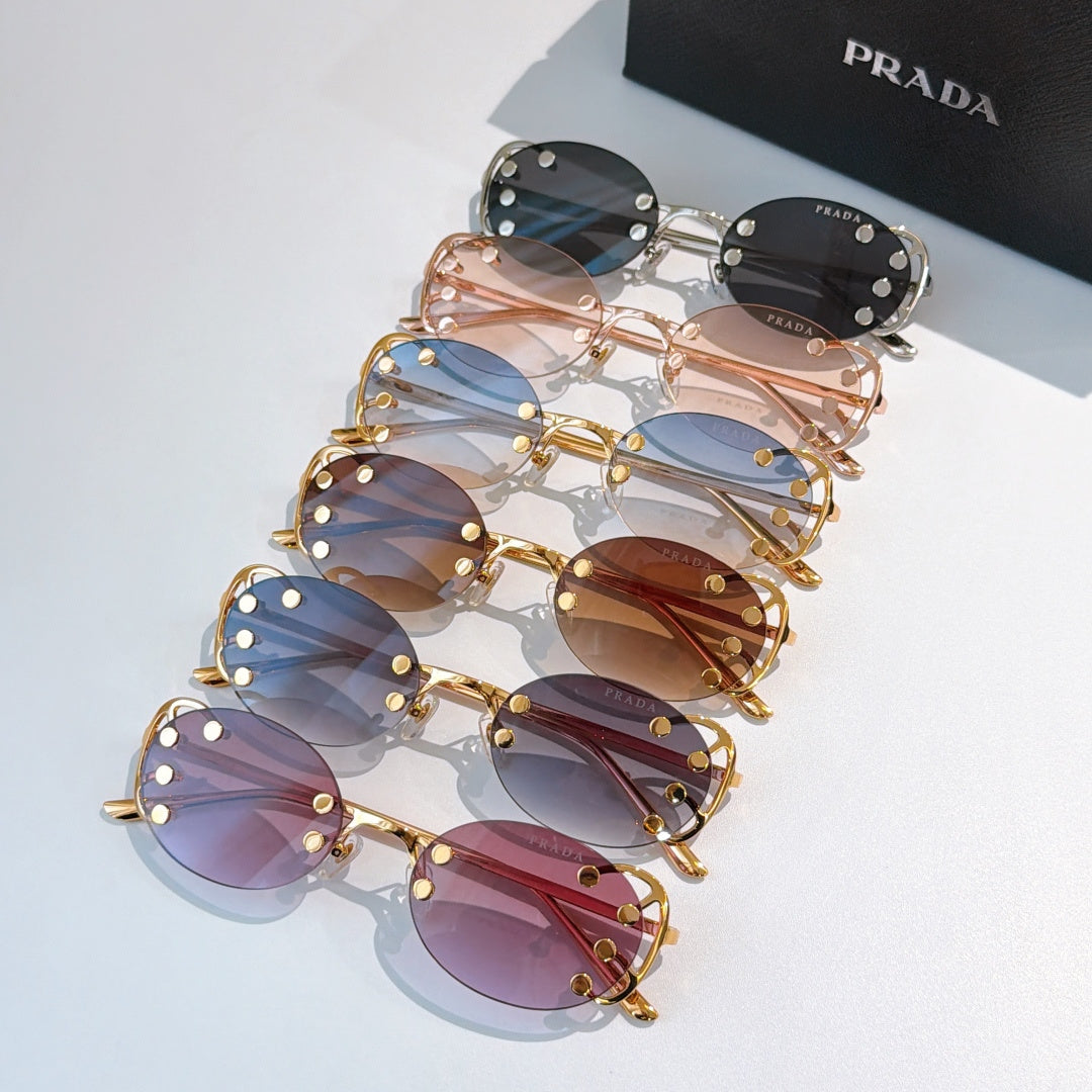Set of Prada sunglasses with assorted colored lenses and gold-tone frames, stacked