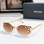 Prada sunglasses with round amber lenses and gold-tone studded frame, slim metal arms
