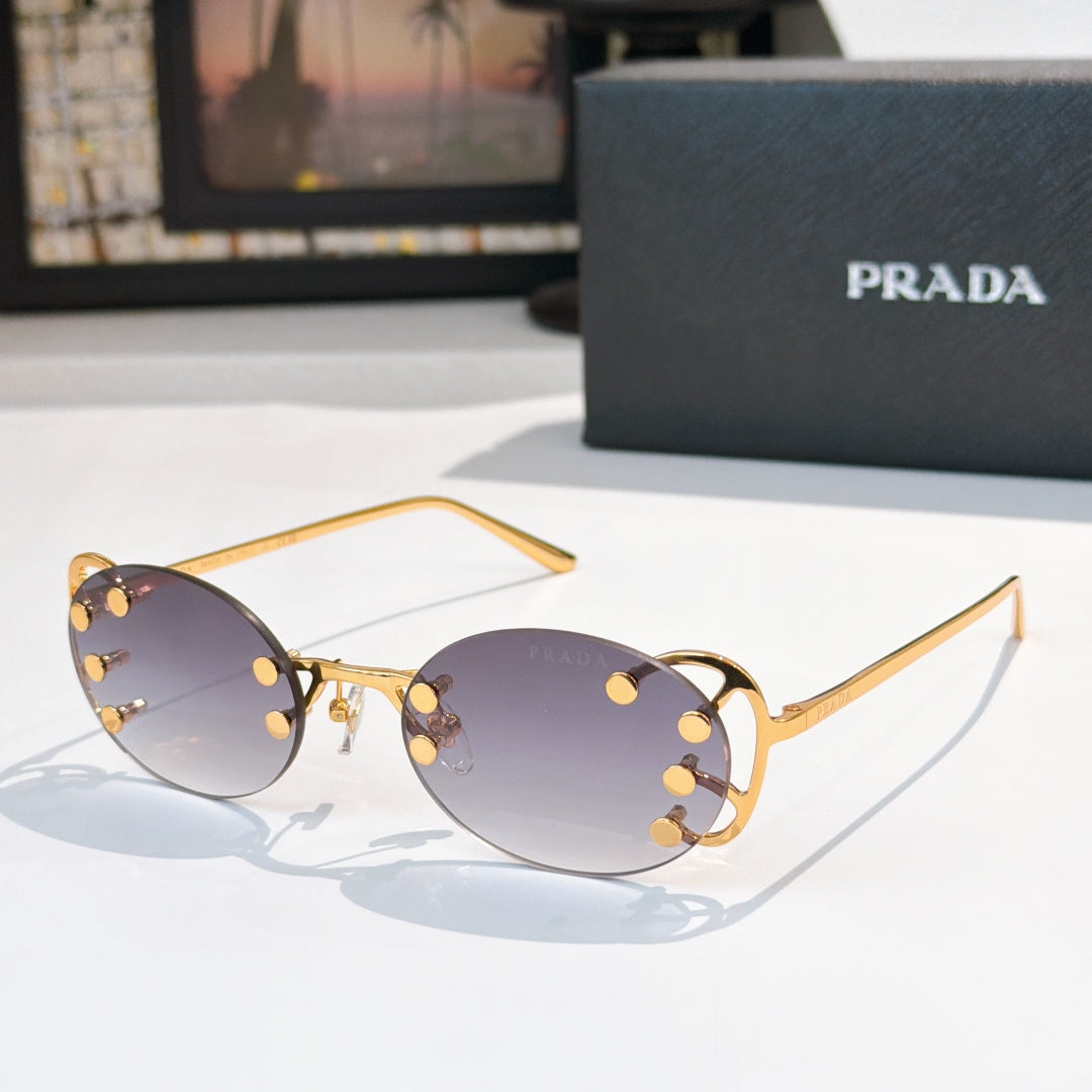 Prada sunglasses with round dark lenses and gold-tone studded frame, slim metal arms