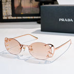 Prada sunglasses with round light-pink lenses and rose-gold studded frame, slim metal arms