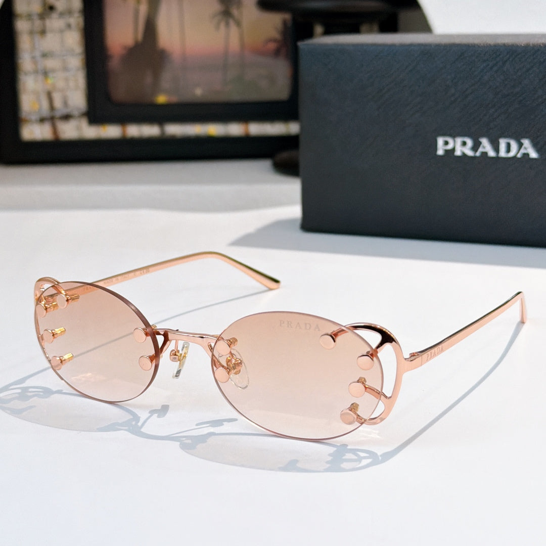 Prada sunglasses with round light-pink lenses and rose-gold studded frame, slim metal arms