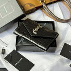 Black small leather bag with croc texture, gold SAINT LAURENT YSL logo on flap