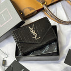 Black croc-textured small leather bag with gold YSL logo on flap