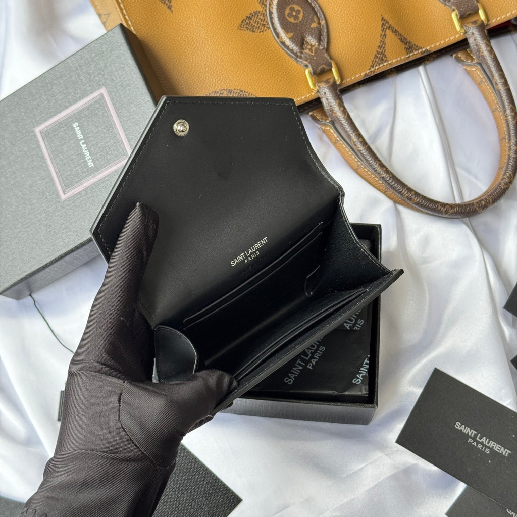 Black small leather bag interior with card slot and SAINT LAURENT printed label