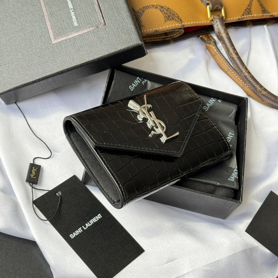 Black croc-textured small leather bag with gold YSL logo, shown at an angle