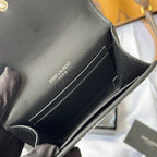 Black small leather bag interior with SAINT LAURENT PARIS text on the lining
