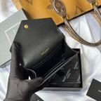 Black small bag with croc front, opened flap shown in gloved hand