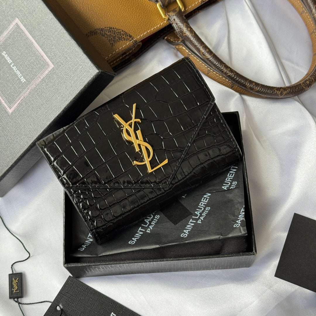 Black croc-textured small bag with gold YSL logo on front flap