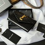 Black croc-textured small bag with gold YSL logo, angled view