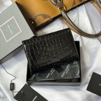 Black croc-textured small bag with gold YSL logo, front flap visible