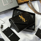 Black croc-textured small bag with gold YSL logo, open gift box view