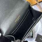 Black small bag interior with stitched edges, held open in gloved hand