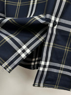 Navy plaid long-sleeve shirt with button placket and collar fold detail