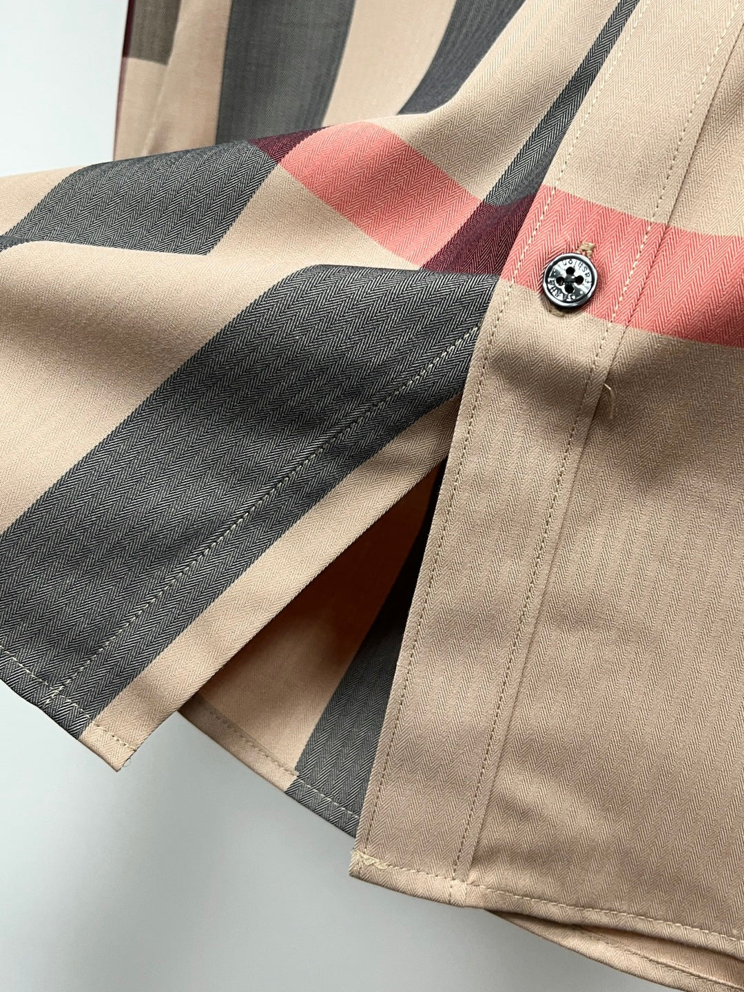 Burberry plaid long-sleeve shirt cuff close-up with button and check pattern